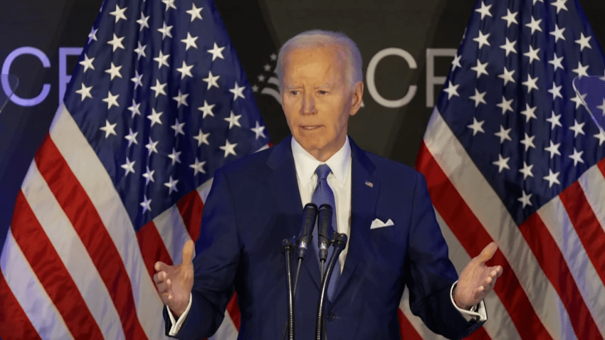 Biden speaks from lectern in front of American flags