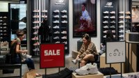 Shoppers try on shoes at a Footlocker store in New York City, U.S., May 16, 2025.