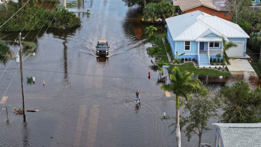 PUNTA GORDA – OCTOBER 10: In this aerial view, a person walks through flood waters that inundated a neighborhood after Hurricane Milton came ashore on October 10, 2024, in Punta Gorda, Florida. The storm made landfall as a Category 3 hurricane in the Siesta Key area of Florida, causing damage and flooding throughout Central Florida. (Photo by Joe Raedle/Getty Images)