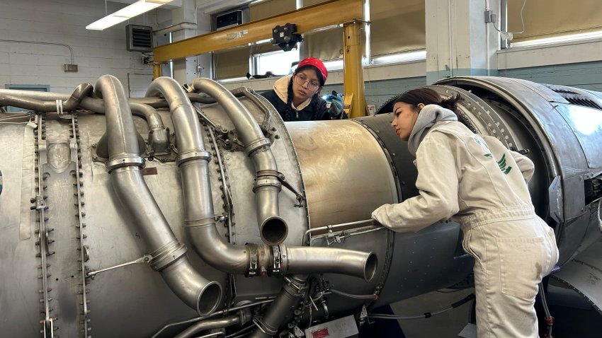 Students work on an airplane engine at Aviation High School in Queens.