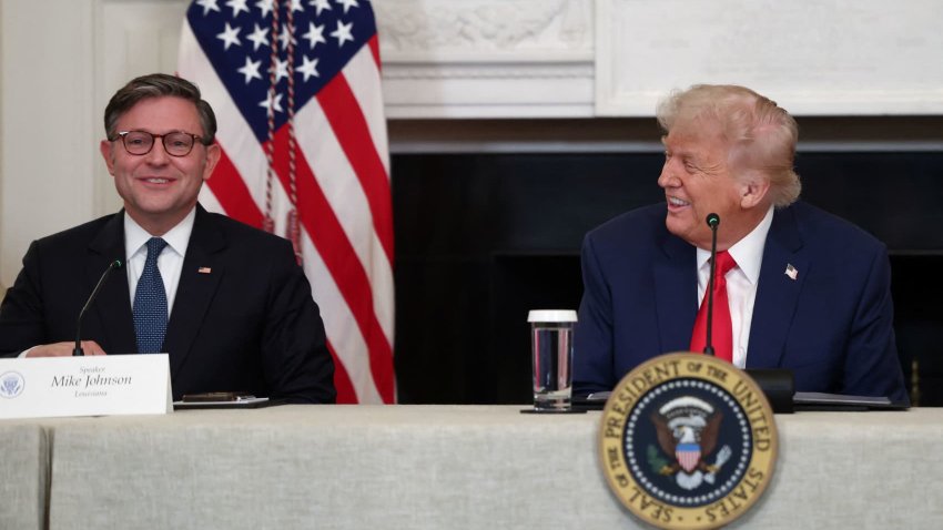 U.S. President Donald Trump and U.S. House Speaker Mike Johnson react during an Invest America Roundtable in the State Dining room, at the White House, in Washington, U.S., June 9, 2025.