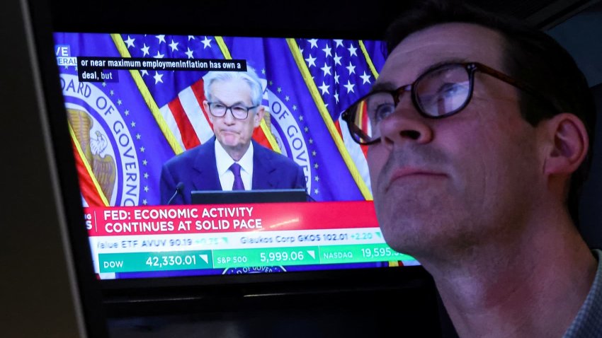 A trader works, as a screen broadcasts a news conference by U.S. Federal Reserve Chair Jerome Powell following the Fed rate announcement, on the floor of the New York Stock Exchange (NYSE) in New York City, U.S., June 18, 2025.
