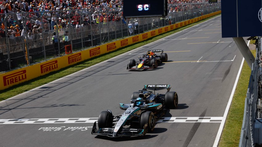 Mercedes' British driver George Russell crosses the finish line