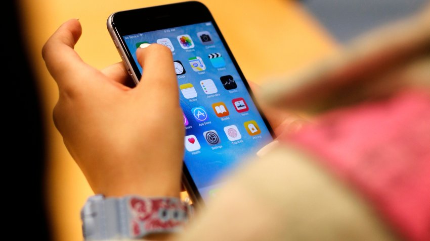 A child holds an iPhone