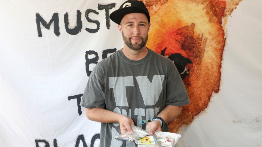 Man holding festival wristbands