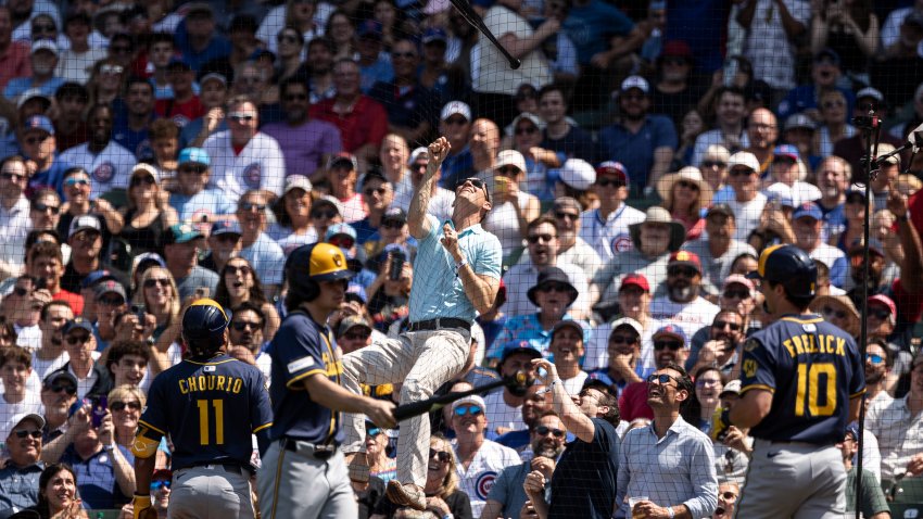 CHICAGO, ILLINOIS – JUNE 19: A fan climbs up the Wrigley Field netting to retrieve a bat that left the hands of Sal Frelick #10 of the Milwaukee Brewers at Wrigley Field on June 19, 2025 in Chicago, Illinois. (Photo by Griffin Quinn/Getty Images)