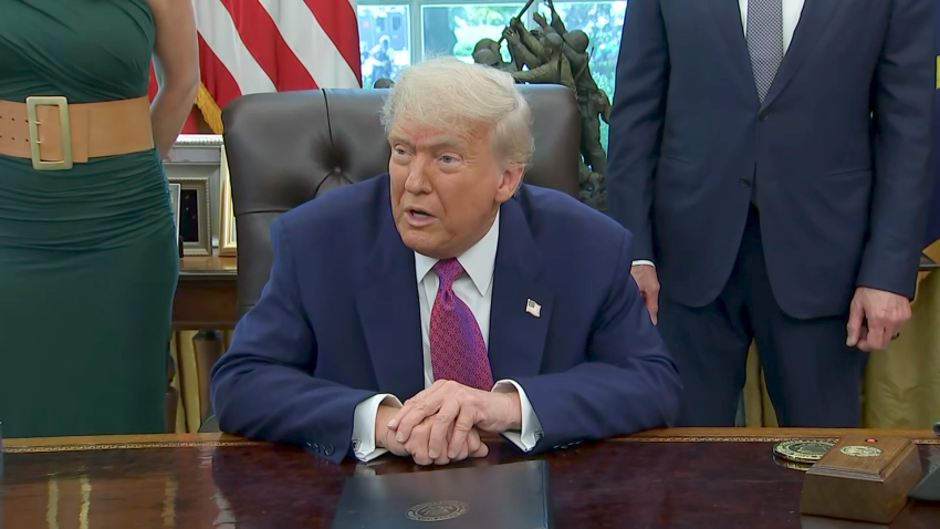Trump sits at resolute desk