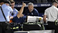 Tampa Bay Rays’ Hunter Bigge gives a thumbs up as paramedics tend to him after being hit by a foul ball while in the dugout during the seventh inning of a baseball game against the Baltimore Orioles, Thursday, June 19, 2025, in Tampa, Fla. (AP Photo/Jason Behnken)
