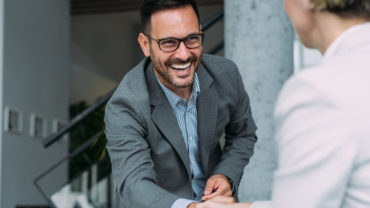 Interview Person Smiling Use these 4 body language tips to ace your job interview, psychologist ...