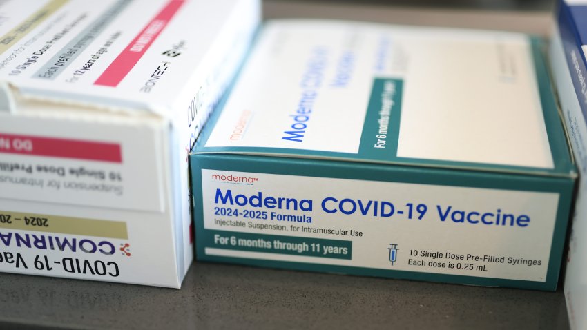 In this photo illustration, Pfizer-BioNTech COVID-19 (L) and Moderna COVID-19 vaccines sit in boxes at Borinquen Health Care Center on May 29, 2025, in Miami, Florida.