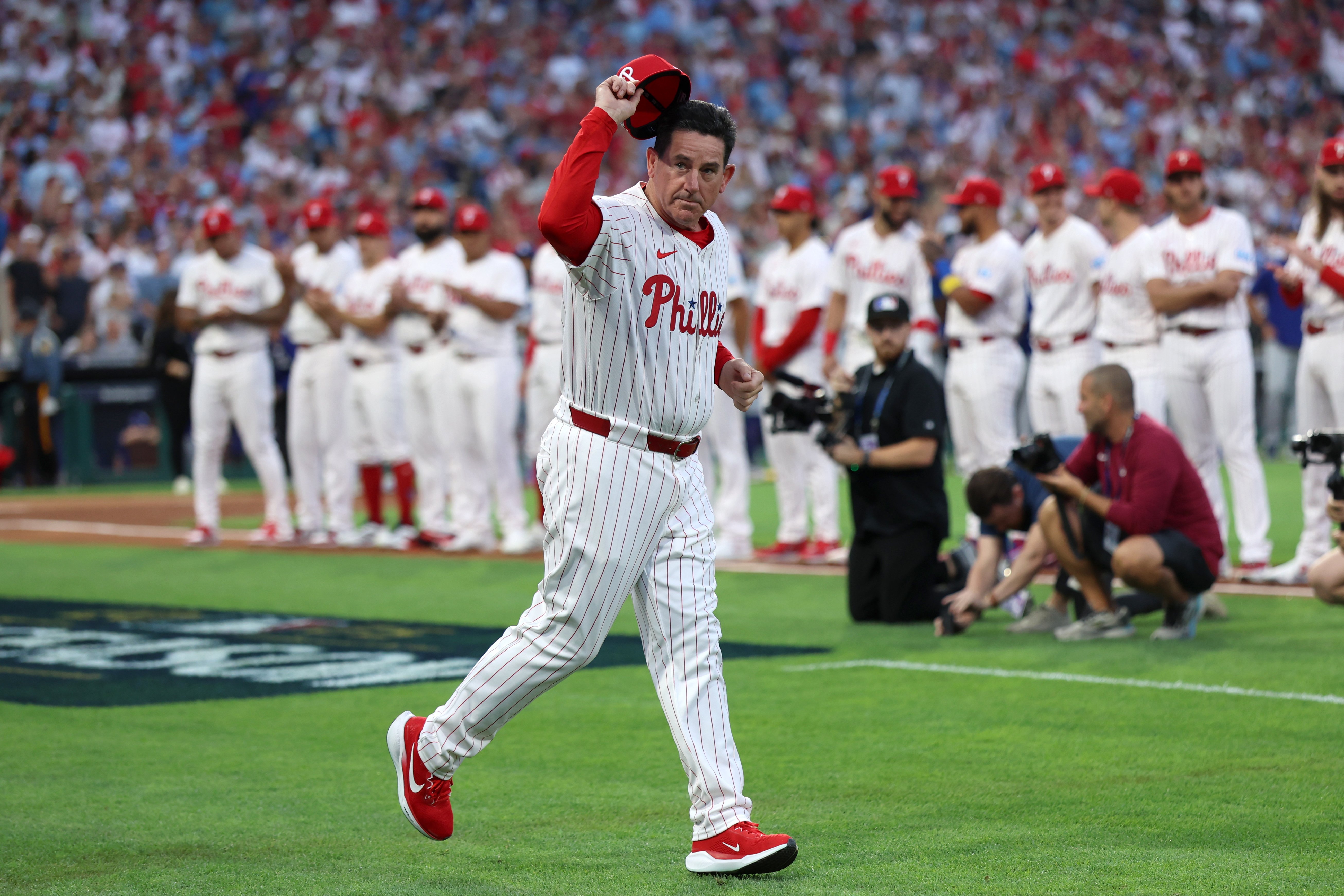 Oct 4, 2025; Philadelphia, Pennsylvania, USA; Philadelphia Phillies manager Rob Thomson (49) is introduced before game one against the Los Angeles Dodgers in the NLDS round for the 2025 MLB playoffs at Citizens Bank Park. Mandatory Credit: Bill Streicher-Imagn Images