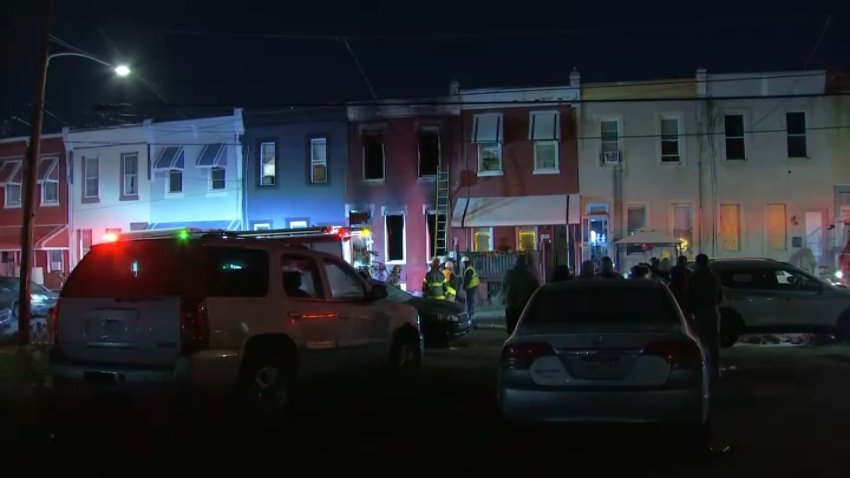 Firefighters respond after a fire tore through a home along North 4th Street in North Philly early Monday.