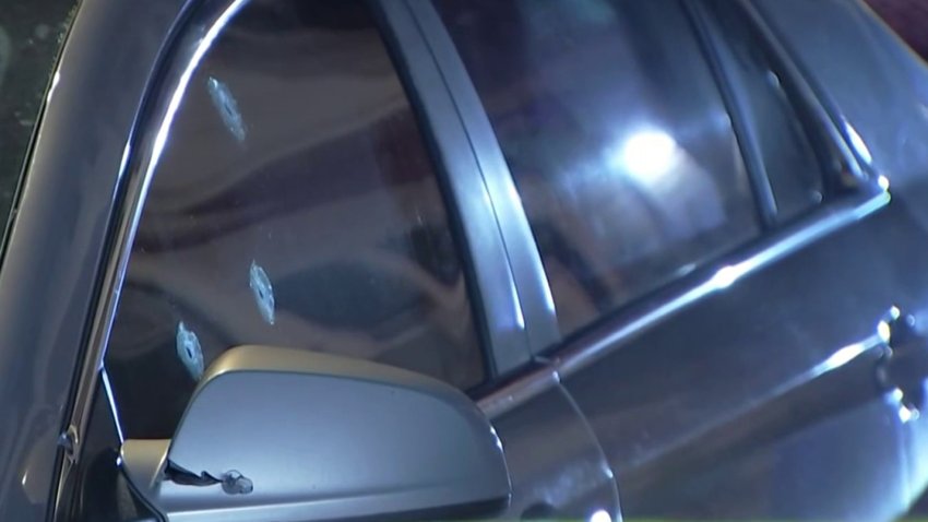 Bullet holes in the window of a vehicle where a woman was hurt when her car was shot at in Philly's Kingsessing neighborhood early Thursday.