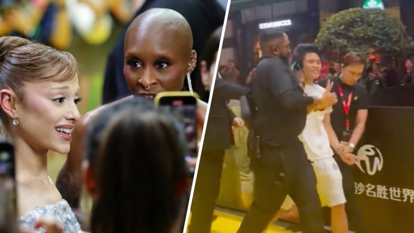 Ariana Grande and Cynthia Erivo attend the “Wicked: For Good” Asia-Pacific Premiere at Universal Studio Singapore on Nov. 13, 2025 in Singapore.  A fan is carried away by security.