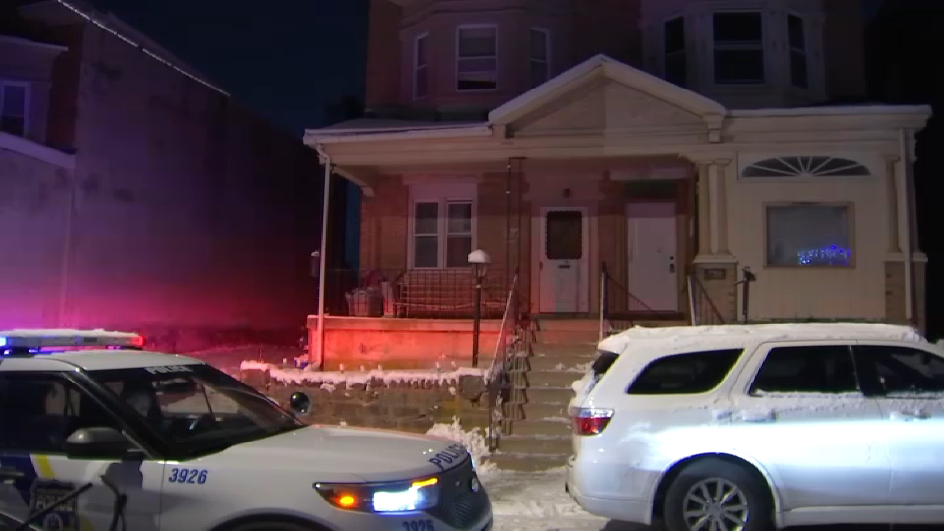 A police car sits outside a home along Abbottsford Avenue in Philly's Germantown section early Monday. 