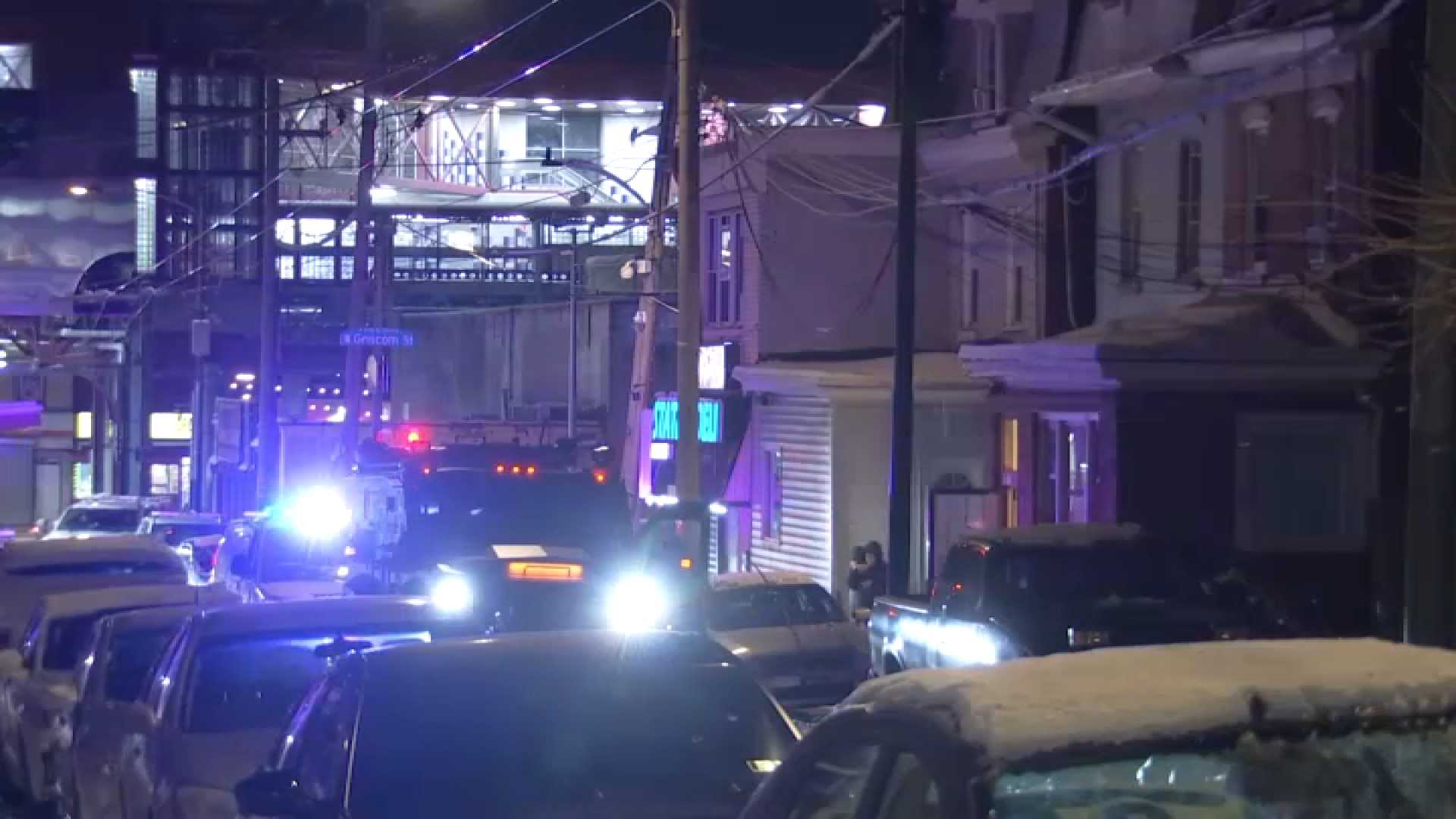 A truck for the Philadelphia Police Department SWAT team sits outside a home along Arrott Street in Philly's Frankford community during a barricade situation there early Monday.