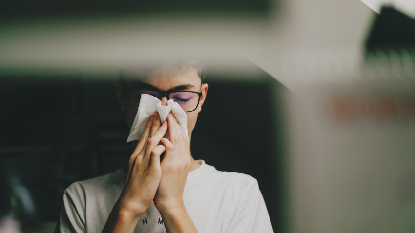 Boy Wiping Runny Nose With a Tissue.