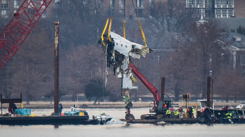 Alexandria, VA – February 3 : A crane is seen from Virginia as it removes airplane wreckage from the Potomac River, where American Airlines flight 5342 collided with a US military Black Hawk helicopter, near Ronald Reagan Washington National Airport, on Monday, Feb 03, 2025 in Alexandria, VA. (Photo by Jabin Botsford/The Washington Post via Getty Images)