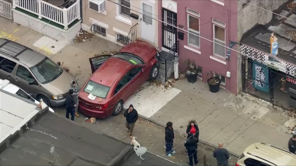 A police officer was hit by a car that struck a home in North Philadelphia, a source confirmed with NBC10.