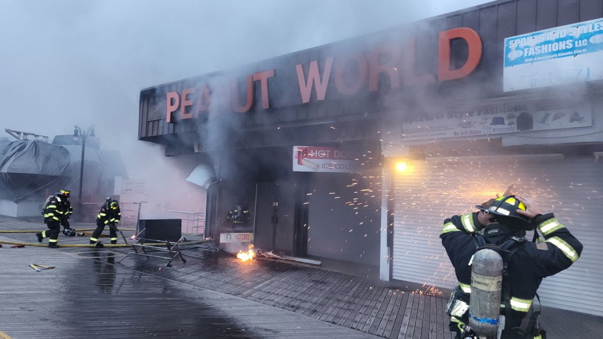Smoke billows from Peanut World as firefighters battle blaze on Atlantic City Boardwalk Friday