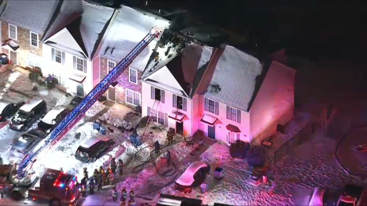 Four people, including a firefighter, were hospitalized in a house fire that happened in New Castle, Del. early Tuesday, officials say.