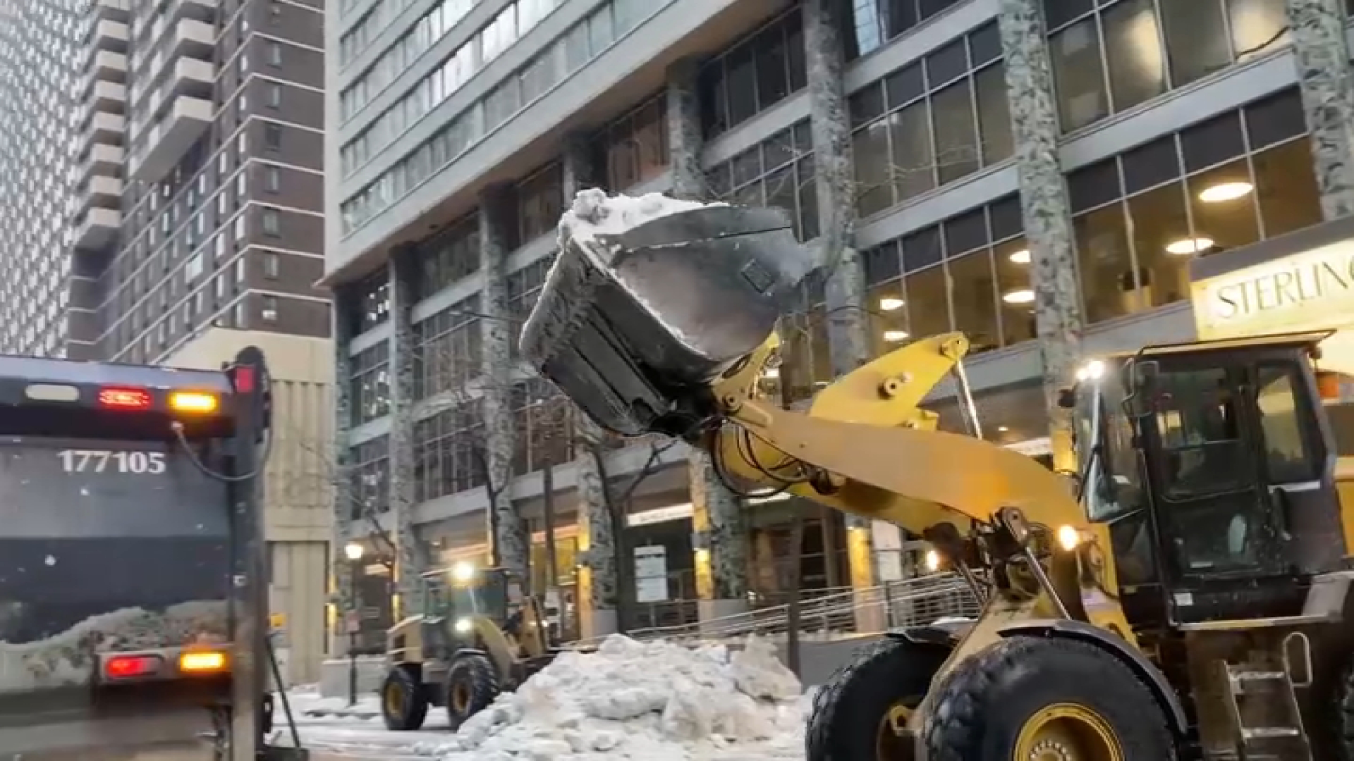 With temperatures above freezing, crews remove large piles of snow in Center City