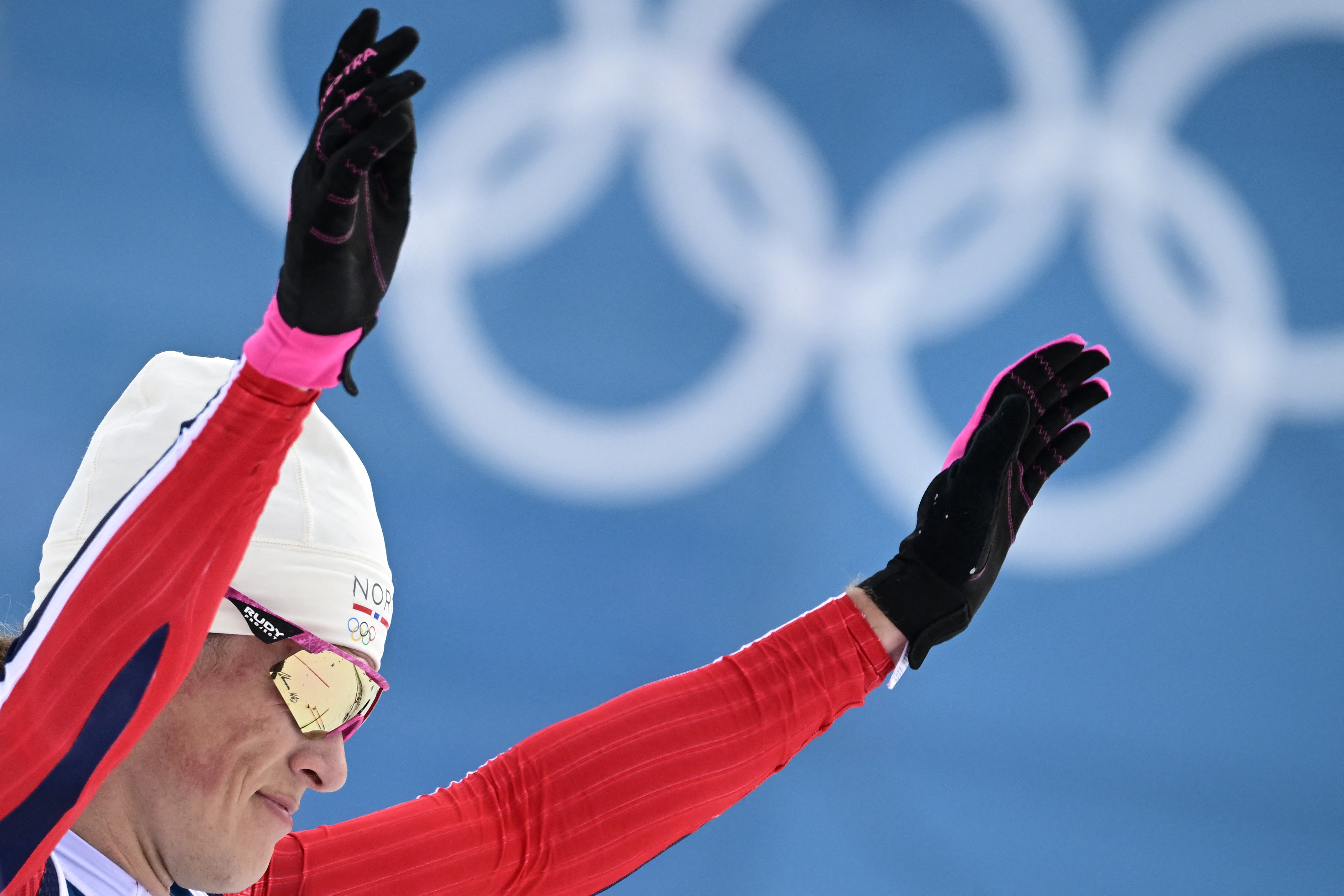 Norway's Johannes Hoesflot Klaebo reacts after he crossed the finish line