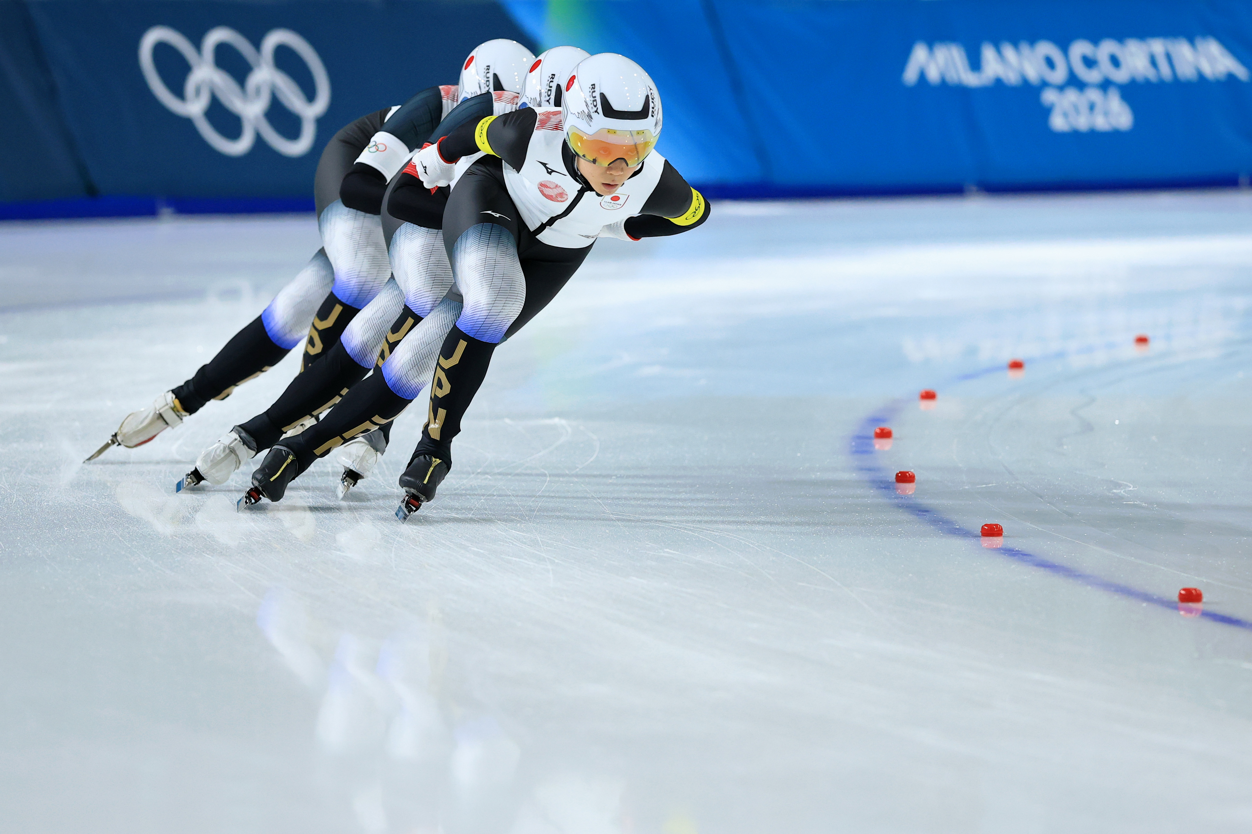 Miho Takagi, Ayano Sato, and Momoka Horikawa of Japan skate during a semifinal in the women's team pursuit.