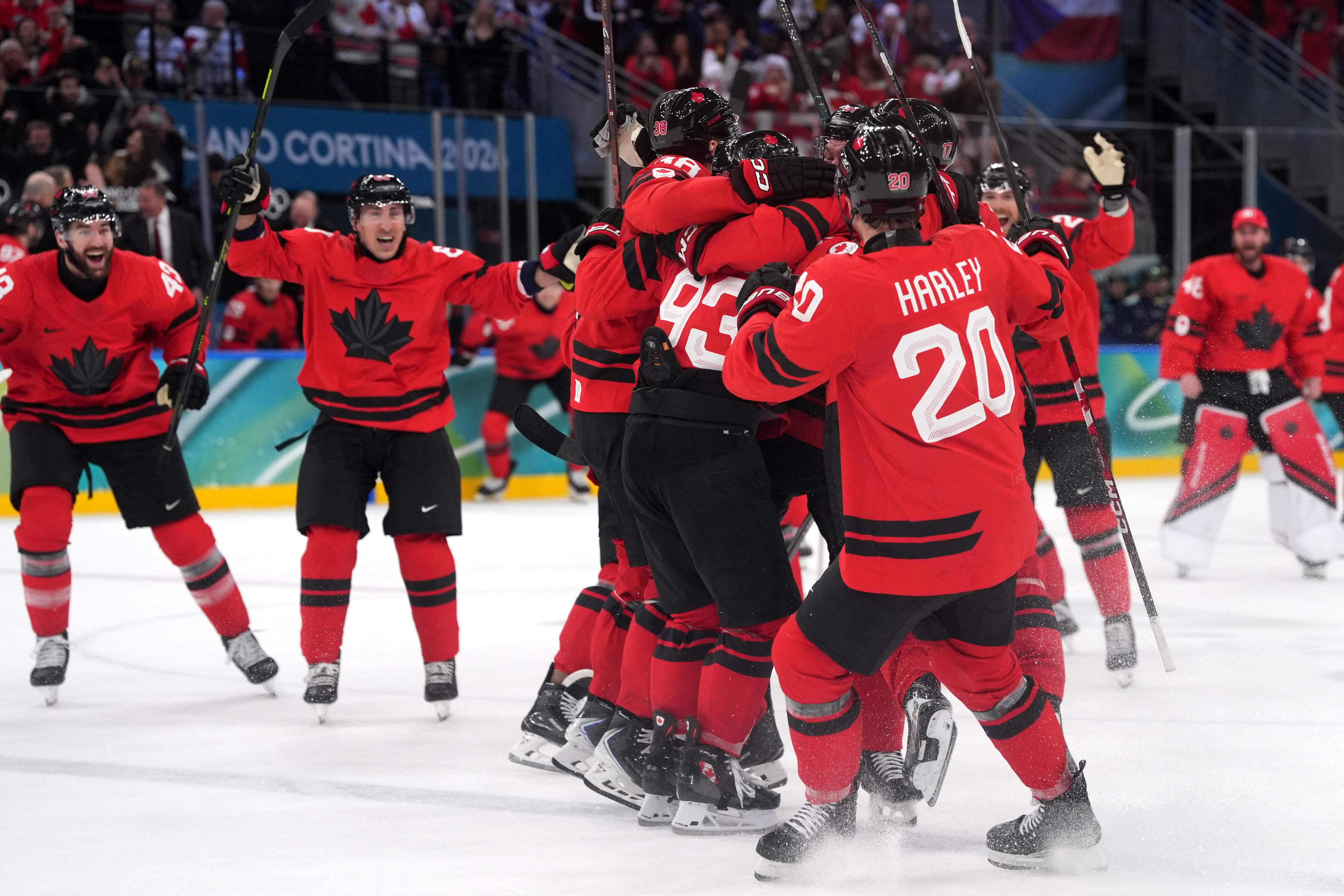 Mitch Marner of Canada celebrates with teammates after scoring their fourth goal in overtime to win the men's hockey quarterfinal against Czechia.