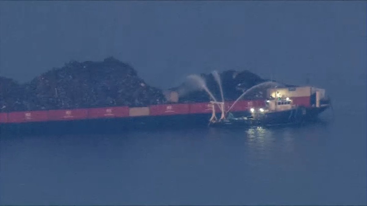 For second day, crews work to extinguish burning barge on the Delaware River