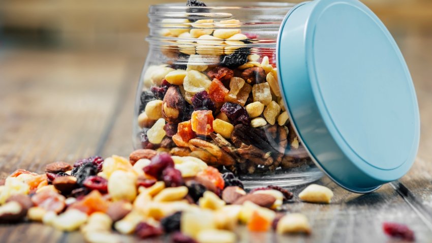 Trail mix in a jar on wooden background