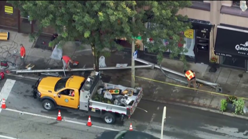 Crews work to clear a downed traffic pole in Lower Merion Township following a crash on Wednesday.