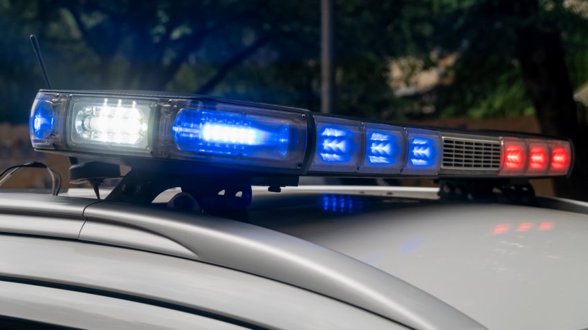 Police are blinking the lights of the car roof in the open air against the backdrop of the mountains. Top police patrol car with flasher and antennas. The patrol car lights up. Close