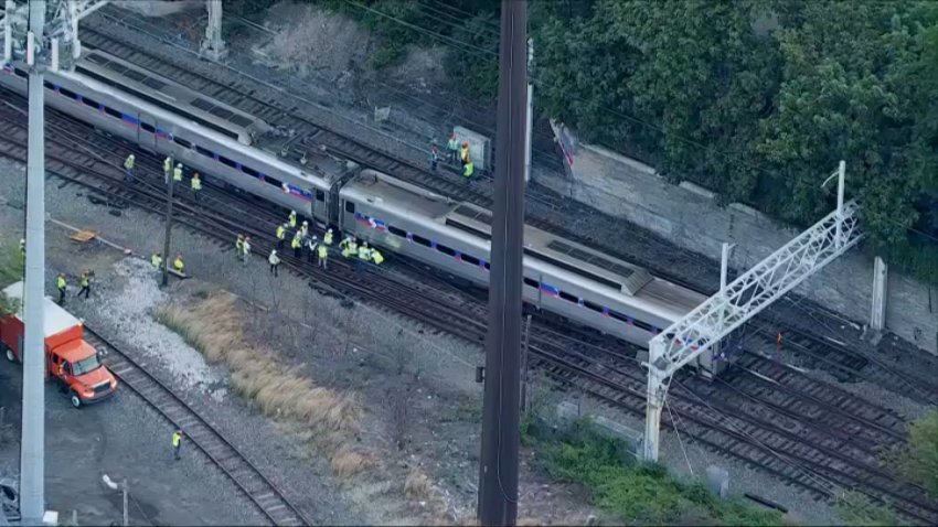 Workers address the situation after a train along SEPTA's Manayunk-Norristown line derailed early Wednesday.