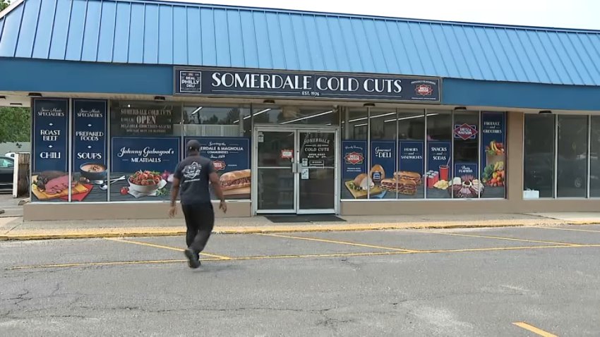 Somerdale Cold Cuts owner Johnny "Gabagool" Aubry walks toward the front door of the business as the deli was set to reopen on Thursday.