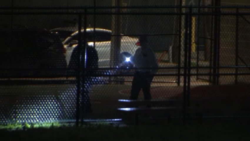 Police investigators search for evidence of a shooting along the 1500 block of North 30th Street in Philadelphia early Tuesday.