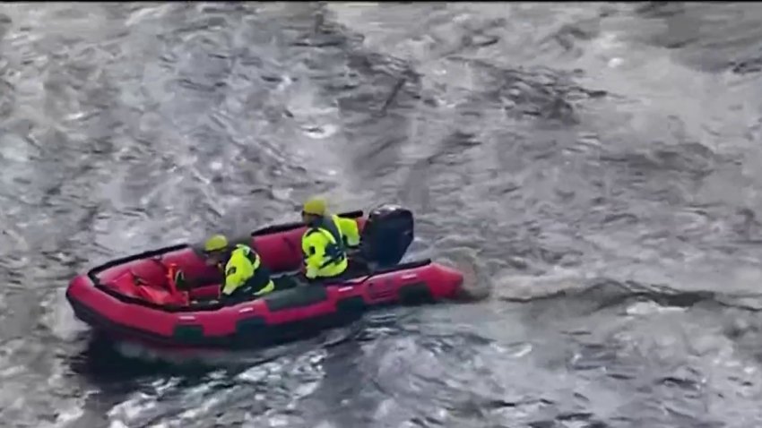 Crews search the Delaware River off of Riverside, New Jersey after a woman disappeared into the water after, officials said, she helped to save a child on Monday.