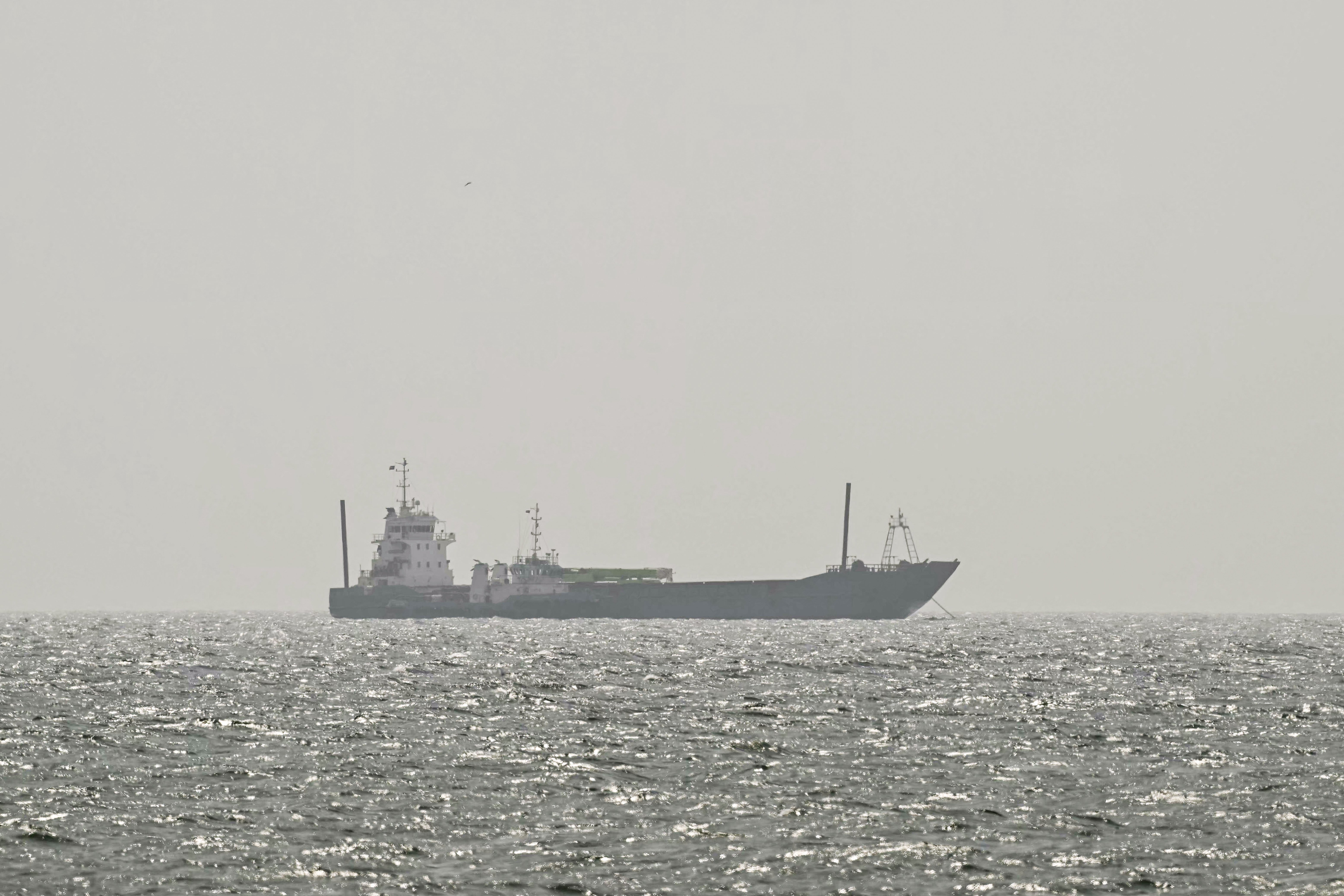 Cargo ship reports being struck in Strait of Hormuz as U.S. and Iran claims about talks diverge