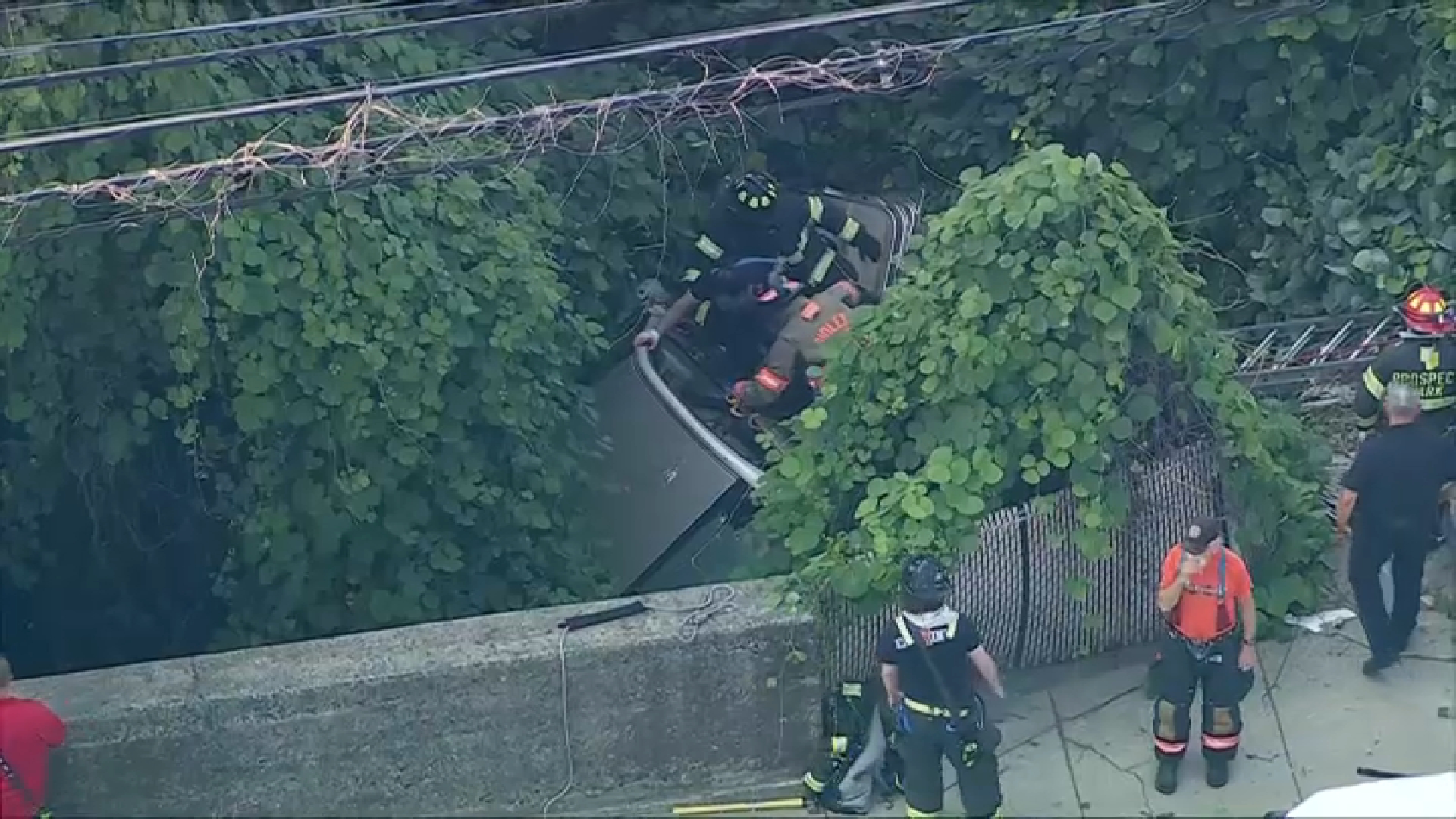 Crews work to pull driver from wreck after vehicle goes over Ridley Park median; driver appears able to speak to rescuers