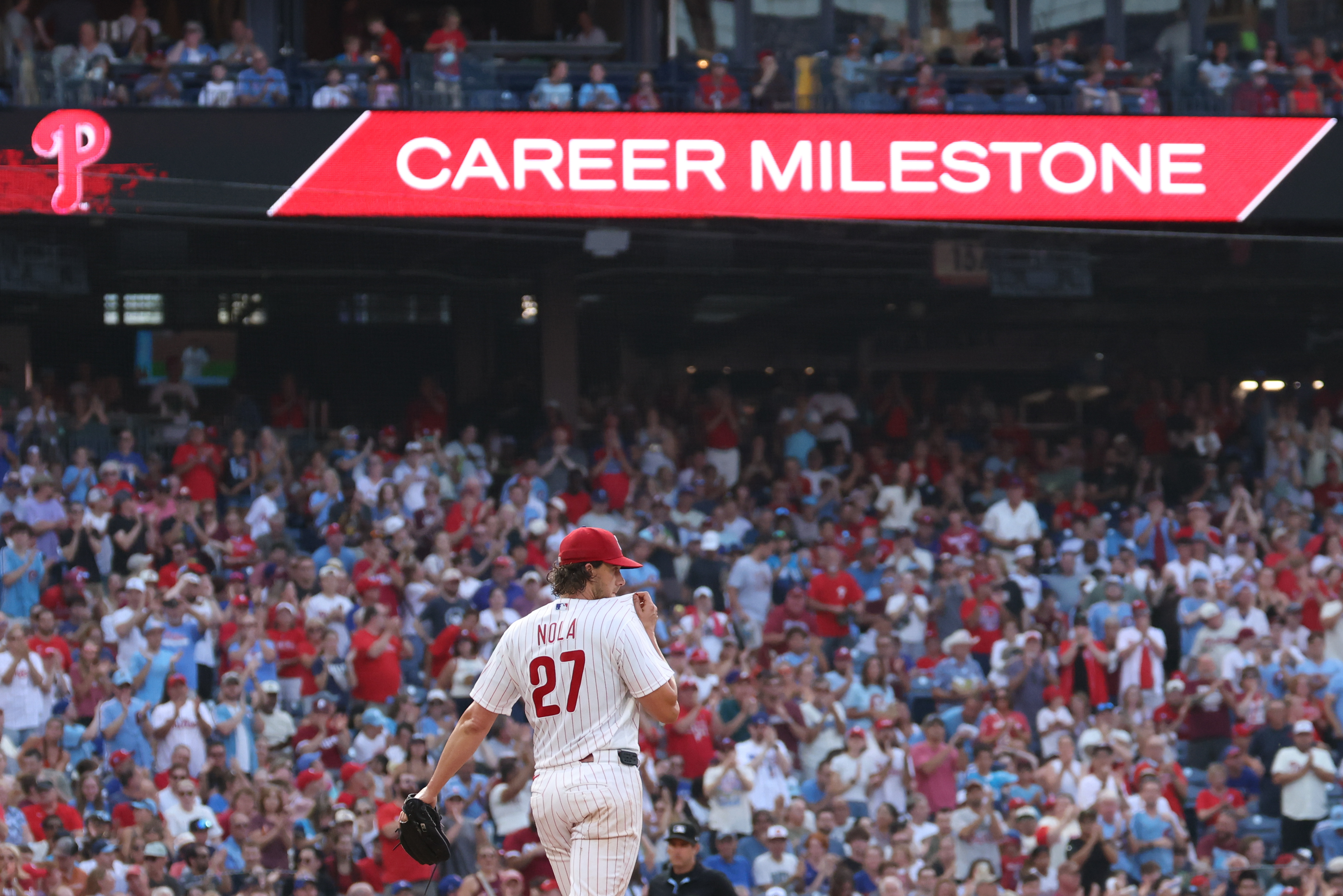 Aug 8, 2026; Philadelphia, Pennsylvania, USA; Philadelphia Phillies pitcher Aaron Nola (27) stands on the mound after recording his 2000 career strike out during the second inning against the Toronto Blue Jays at Citizens Bank Park. Mandatory Credit: Bill Streicher-Imagn Images