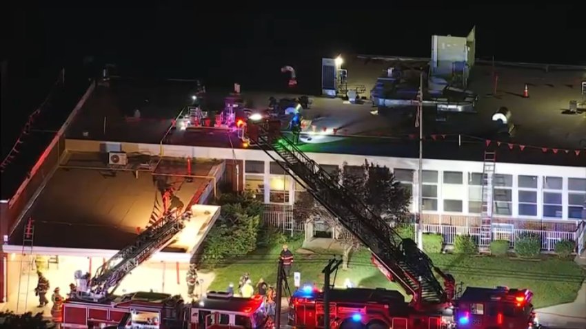 Firefighters on the roof of Lindenwold Elementary School 4 after a fire broke out there on Tuesday night.