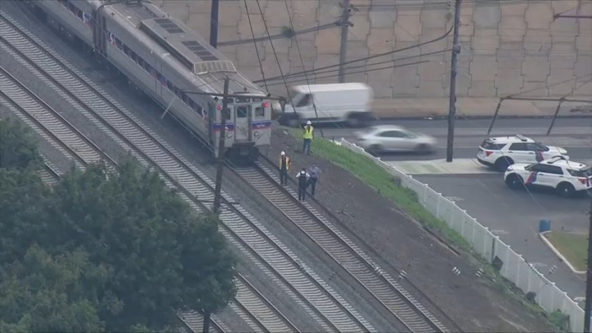 Crews work on the tracks along SEPTA's Wilmington/Newark Regional Rail Line after a medical emergency halted trains on Friday morning.