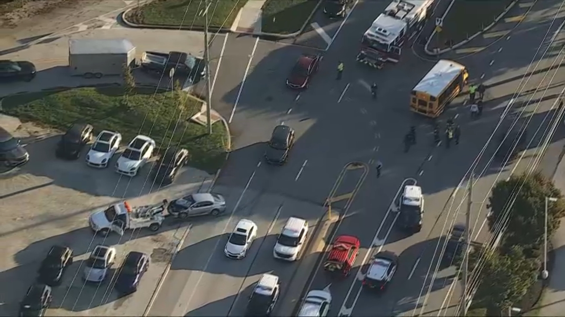 A damaged vehicle being towed after crews turn a school bus back upright after it turned onto its side in a crash in Newtown Township on Wednesday morning. 