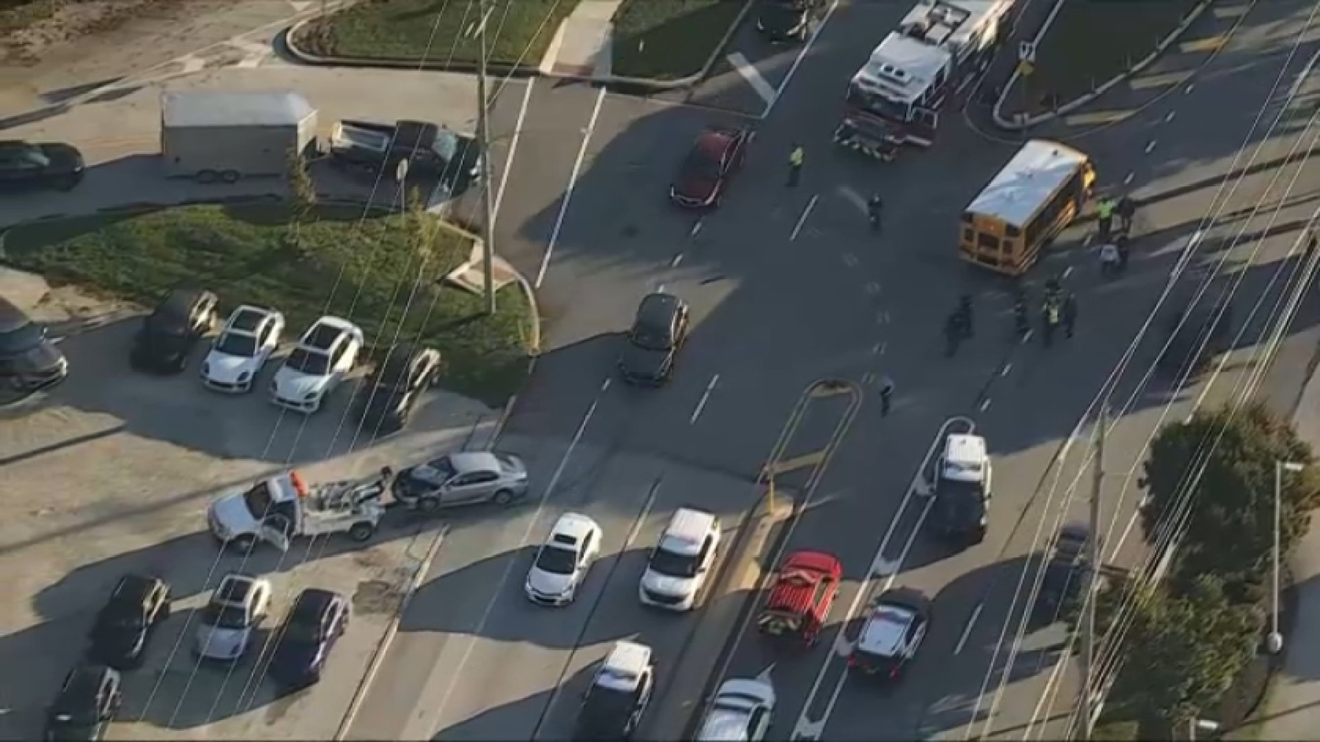 A damaged vehicle being towed after crews turn a school bus back upright after it turned onto its side in a crash in Newtown Township on Wednesday morning.